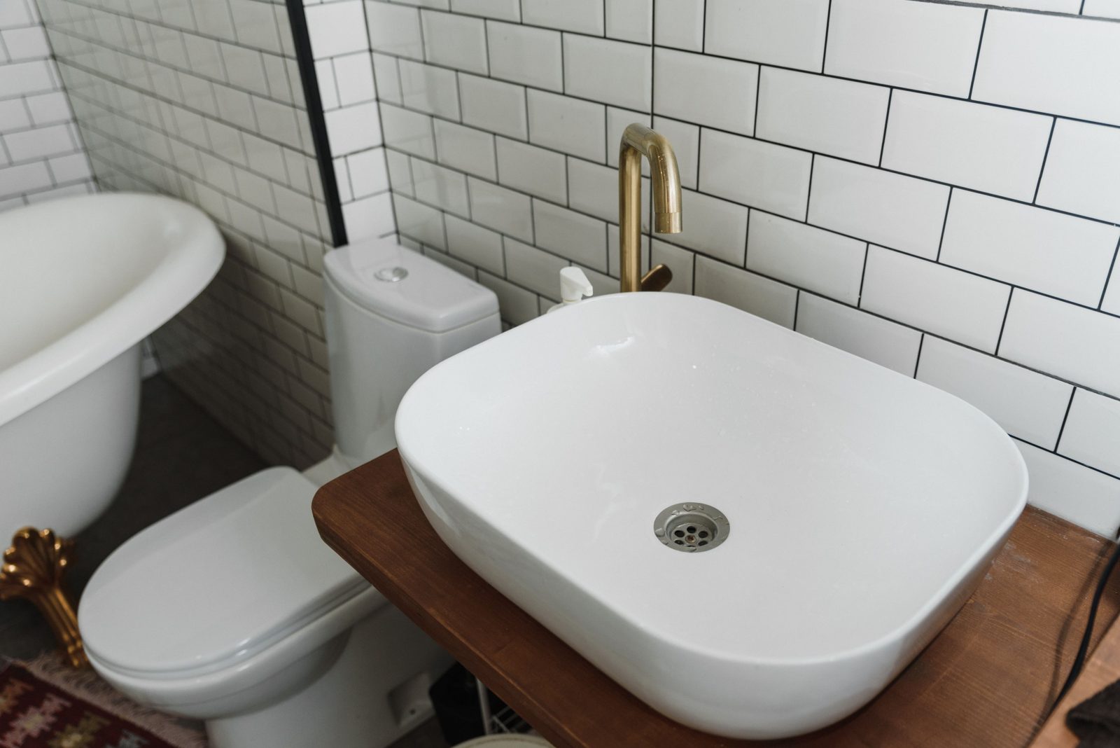 Vessel sink with brushed brass faucet
