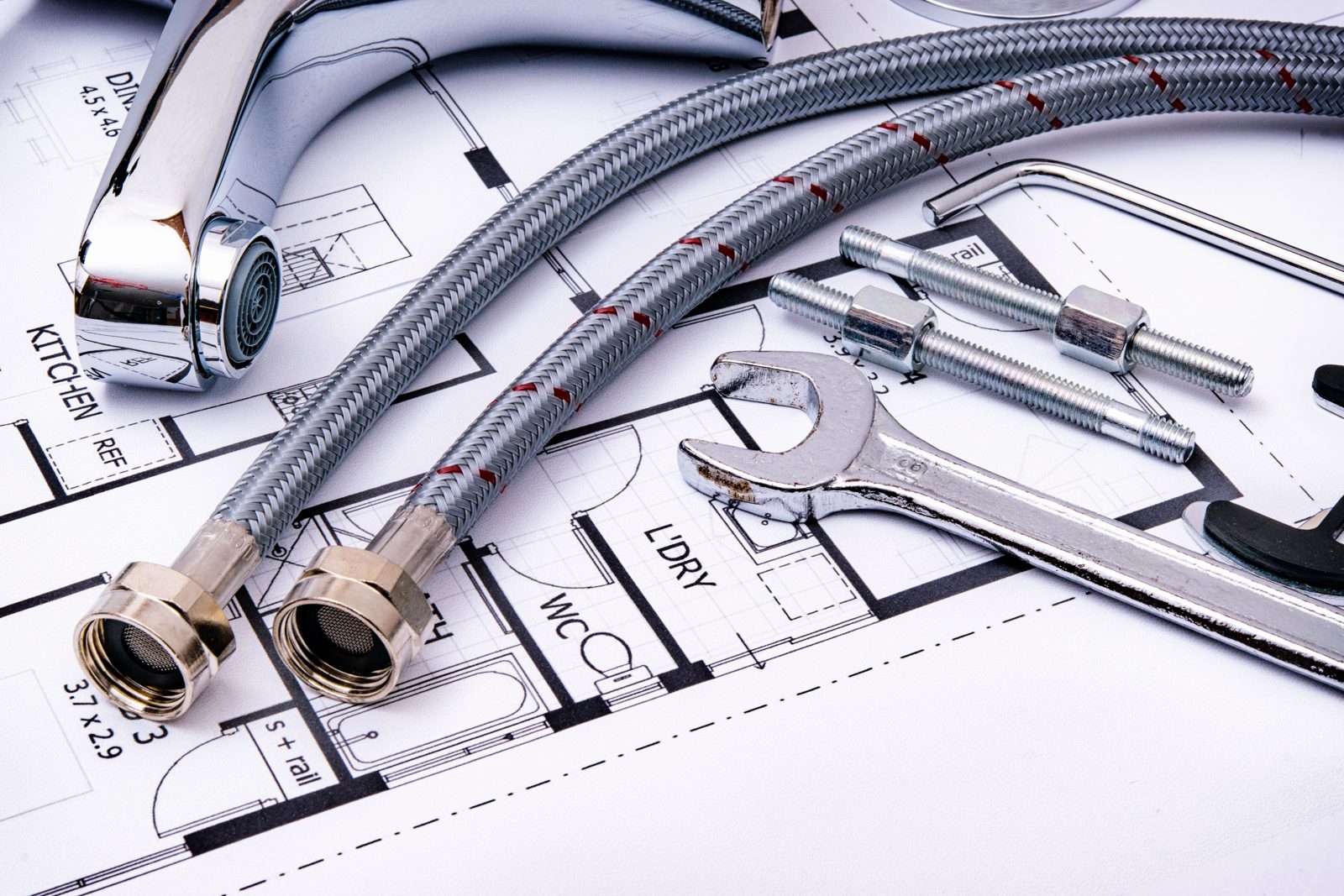 Faucet, supply lines and wrench laid on a floor plan