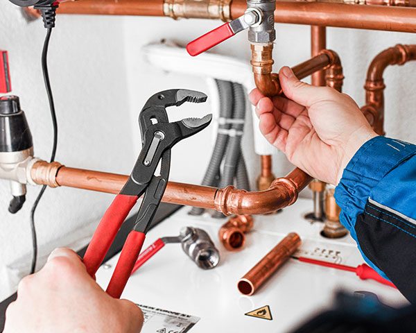 Copper pipe fittings being installed
